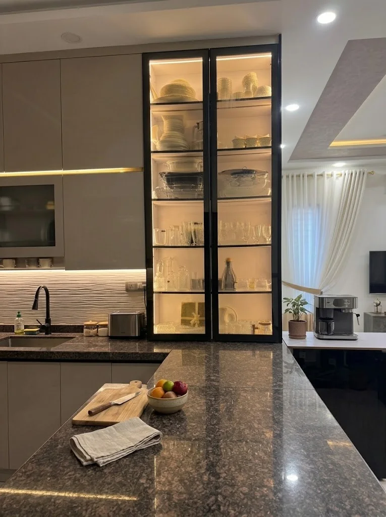 Glass cabinetry after dark. Kitchens & Custom Furniture from the Mock Rock Gardening portfolio.